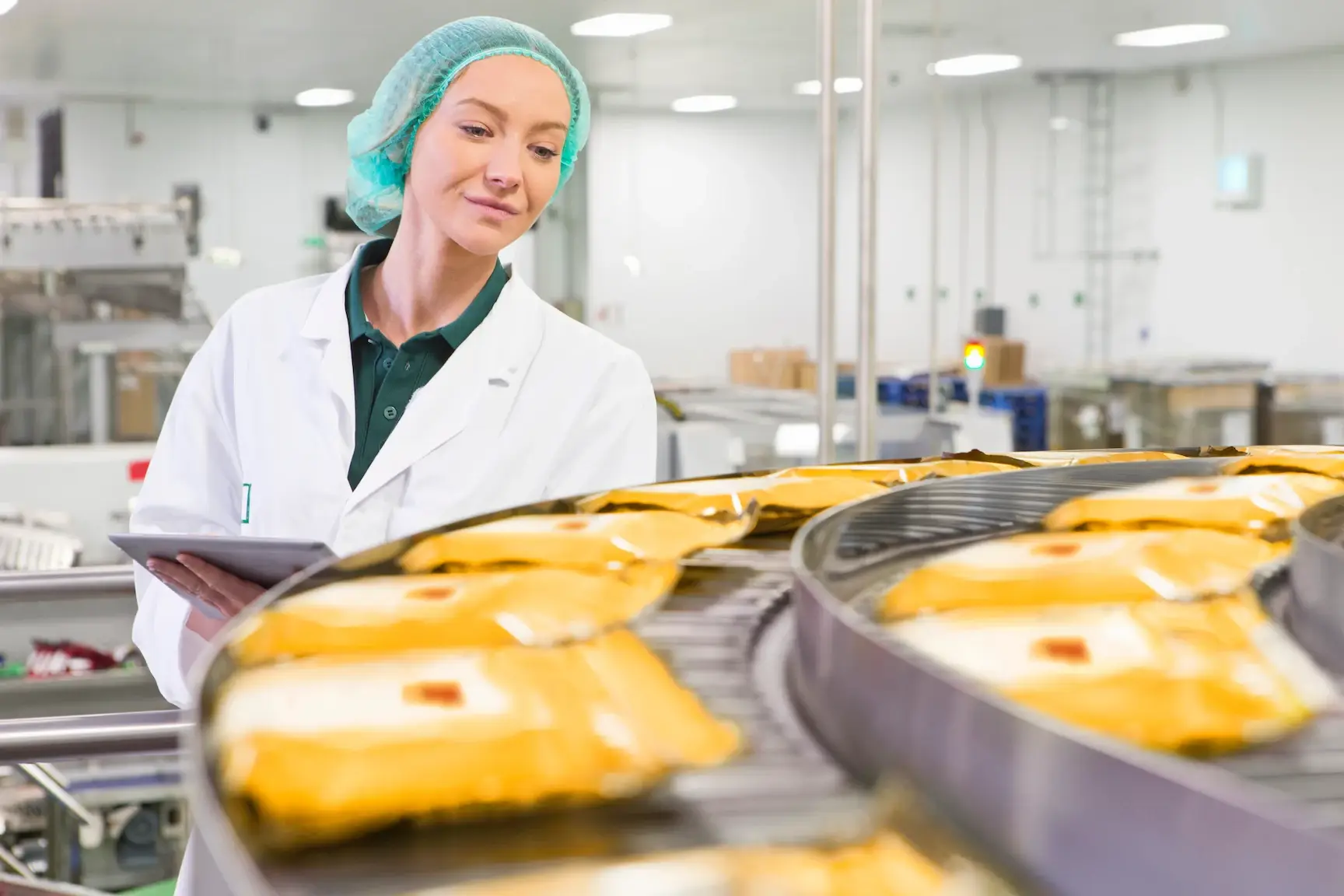 Worker monitoring food packaging process.