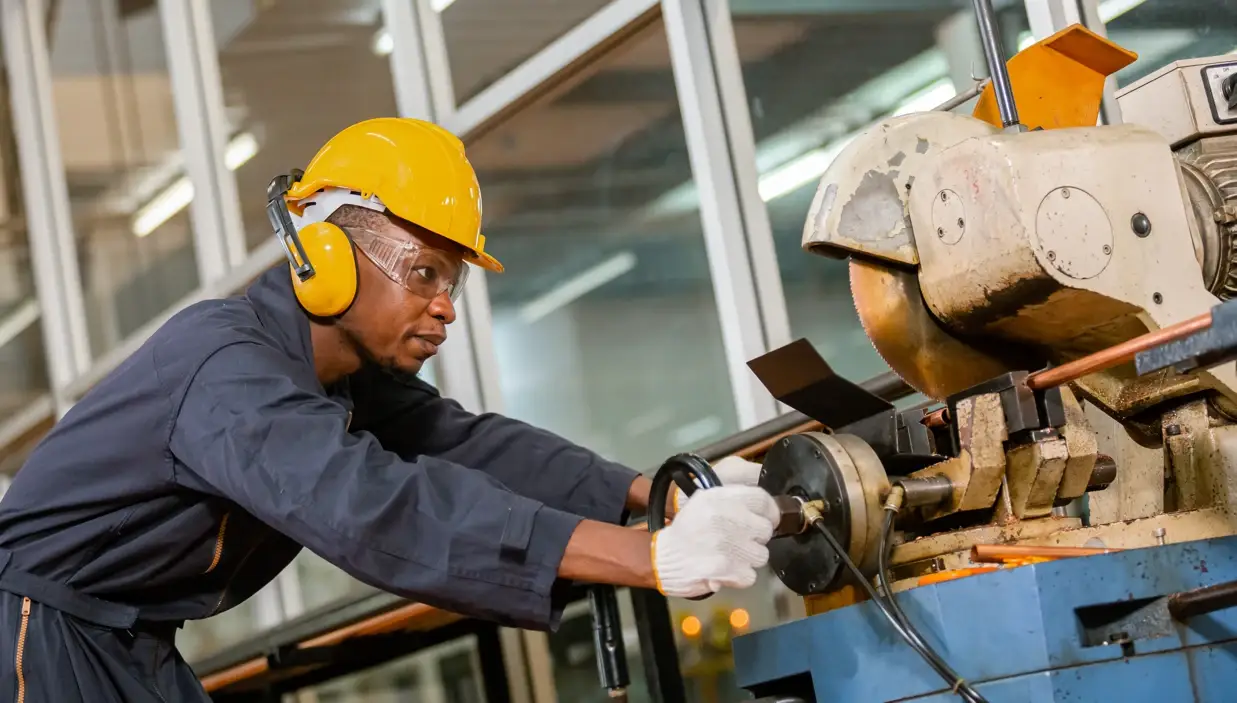Worker operating machinery in factory